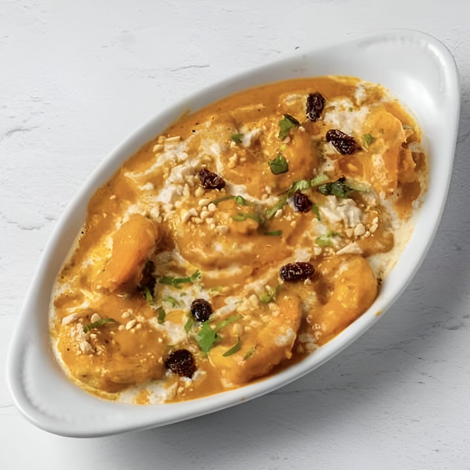 Malai Kofta, Indian cheese and vegetable dumplings in a creamy cashew and raisin sauce.